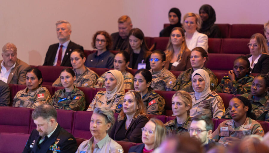 People in the audience, some wearing uniforms.