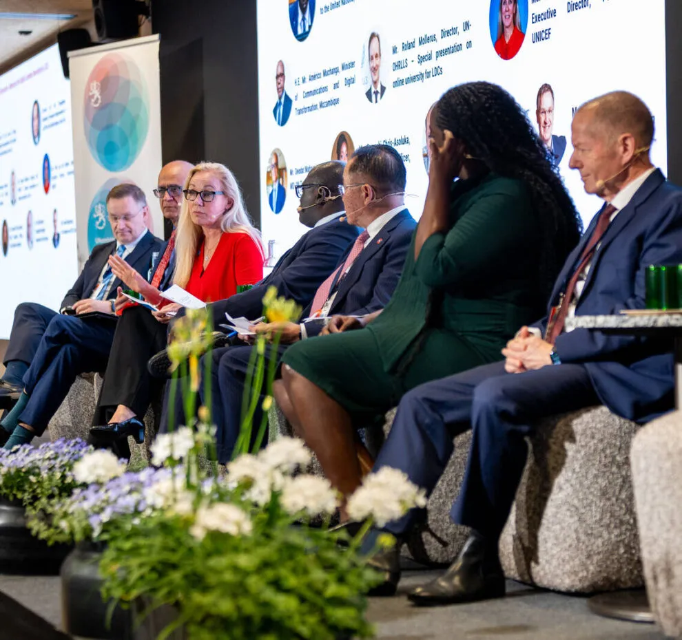 People seated on stage in a panel discussion setting.