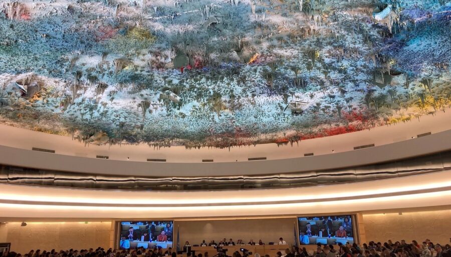 Photo of the UN Human Rights Council chamber with its colorful ceiling.