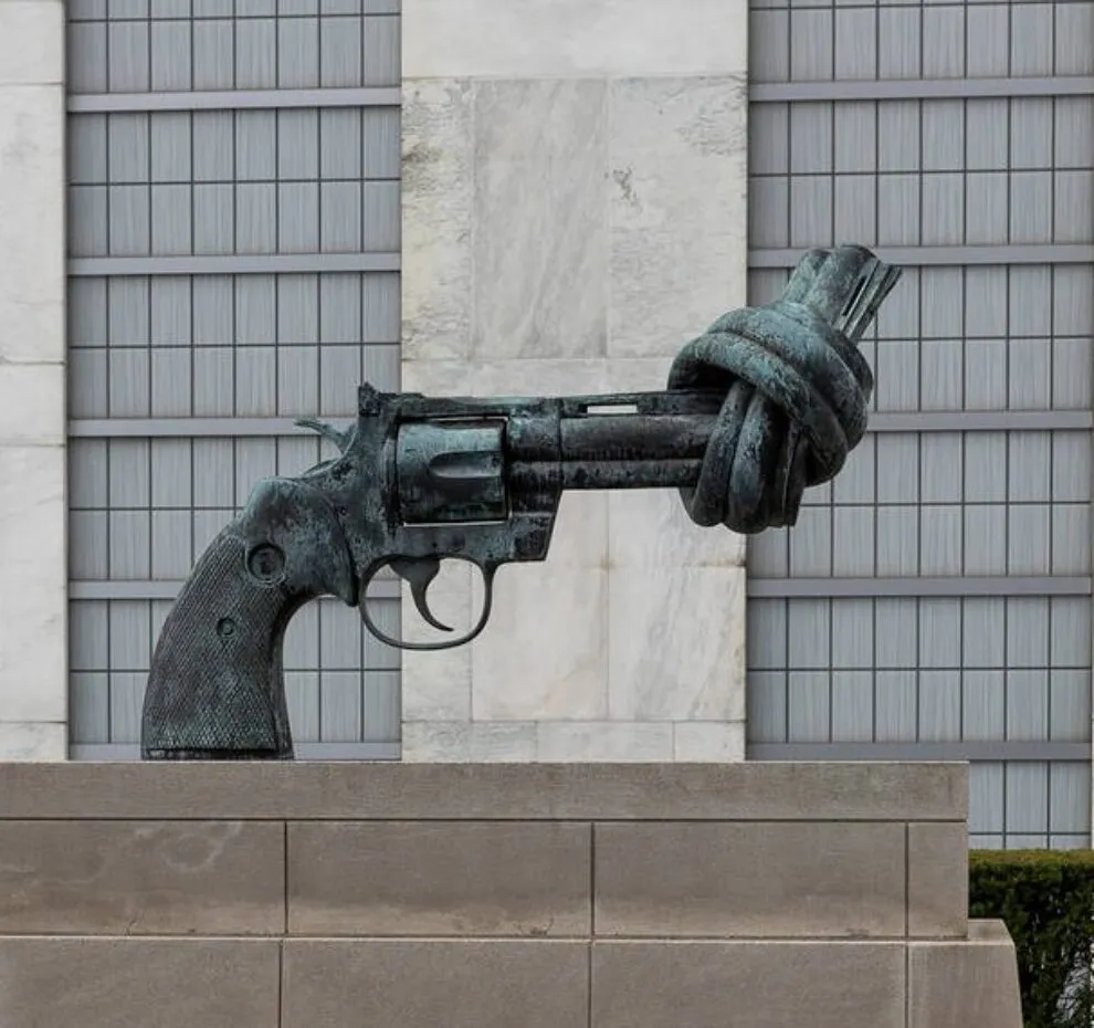 A sculpture in front of the UN headquarters depicting a gun with its barrel tied in a knot.