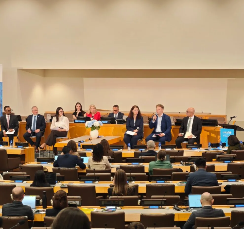 People participating in a panel discussion in a conference room.