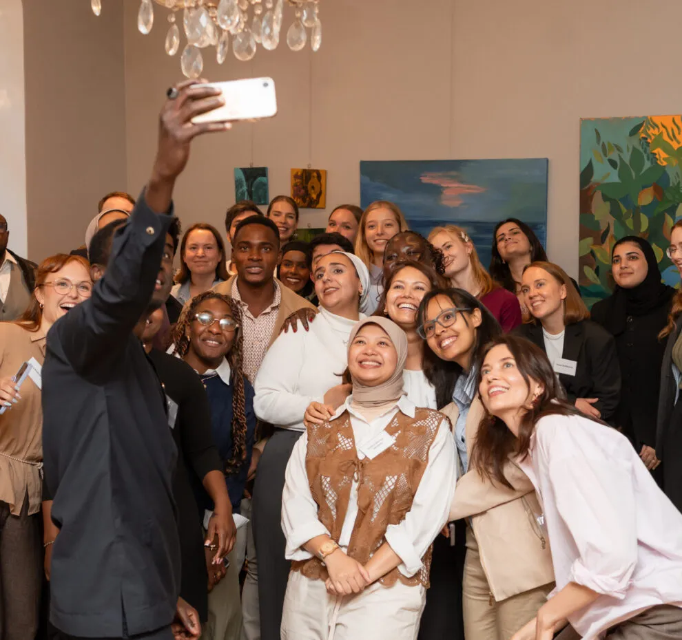 Group of young people taking a selfie together.